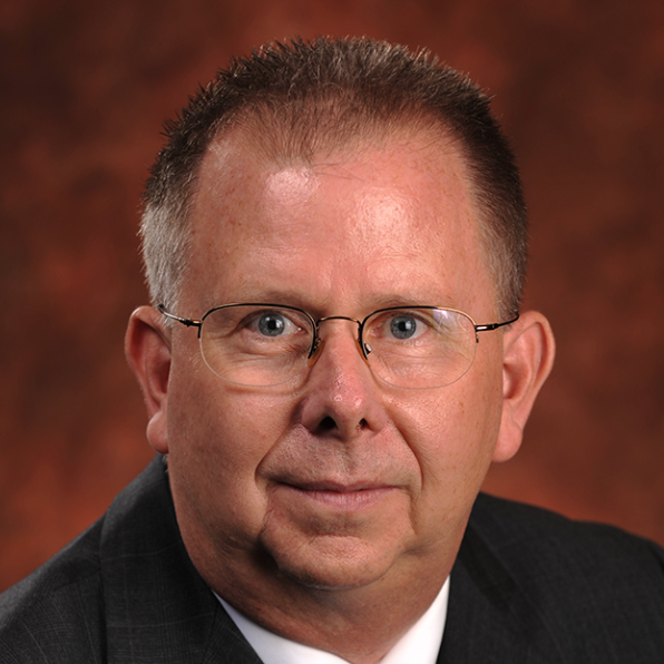 Man in round glasses smiling