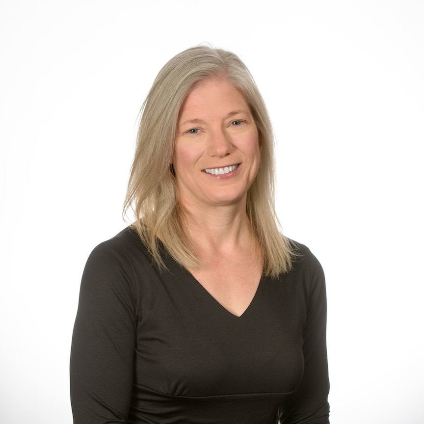 Woman in gray hair and glasses