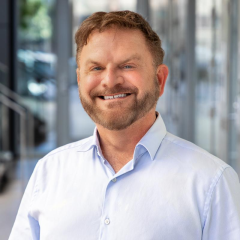 Man in beard and blue shirt smiling