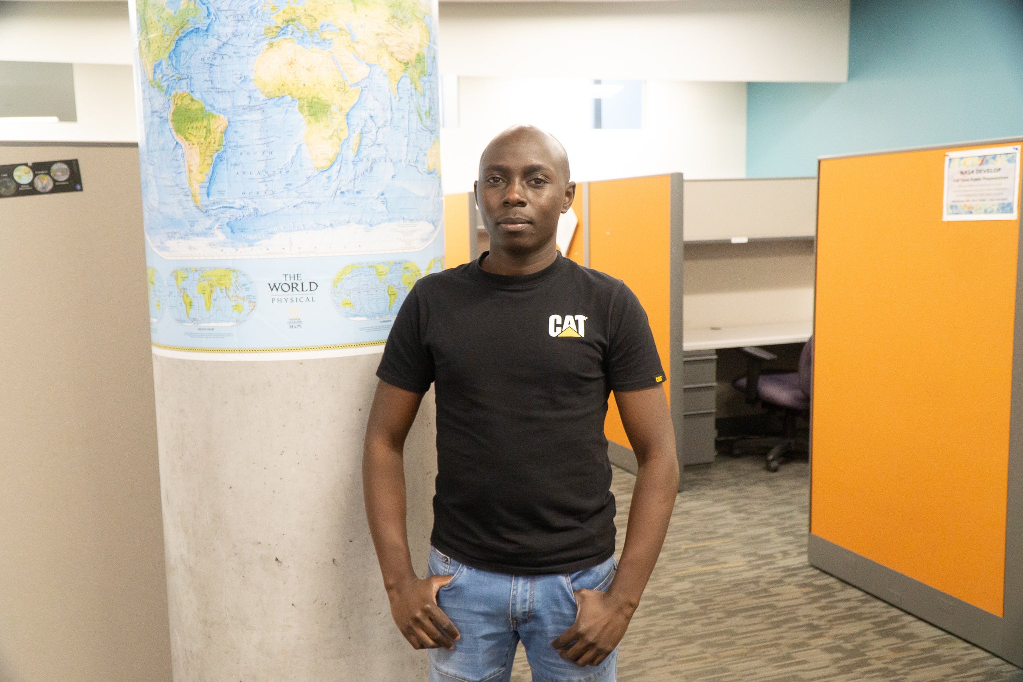 portrait of Joseph Karanja in front of a map