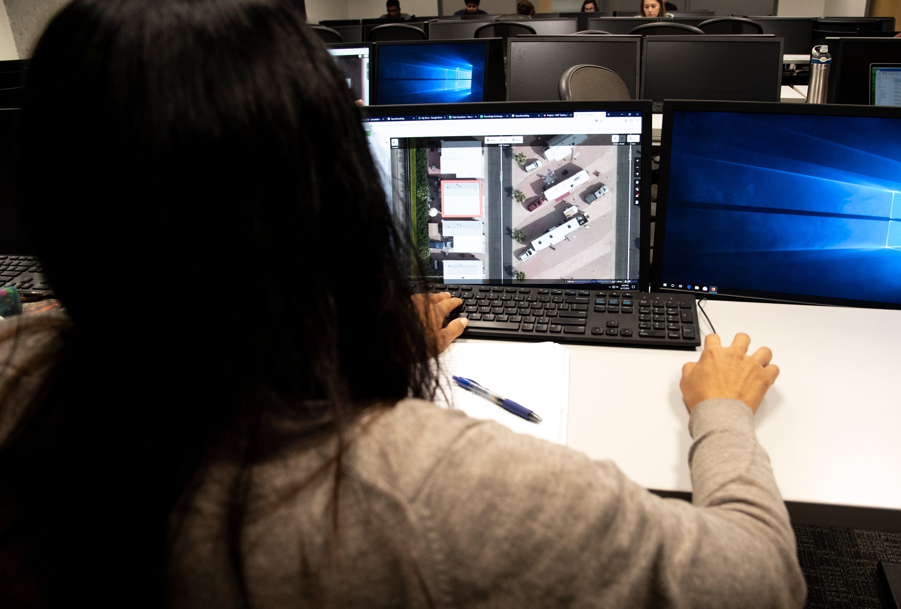 Researcher Elisha Charley studies a Mesa area satellite image at the KER lab on the Tempe campus. 