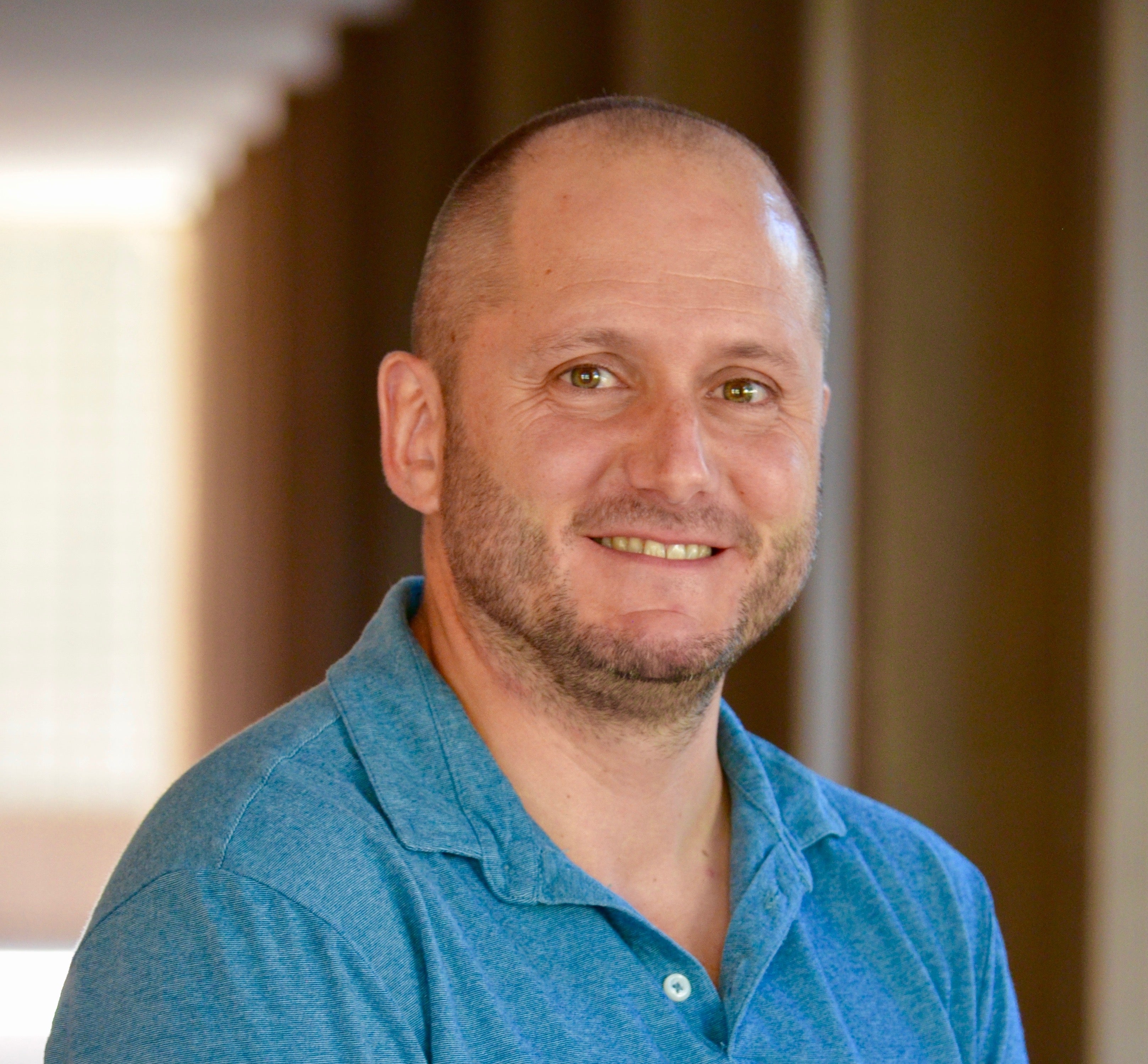 Man in blue shirt smiling