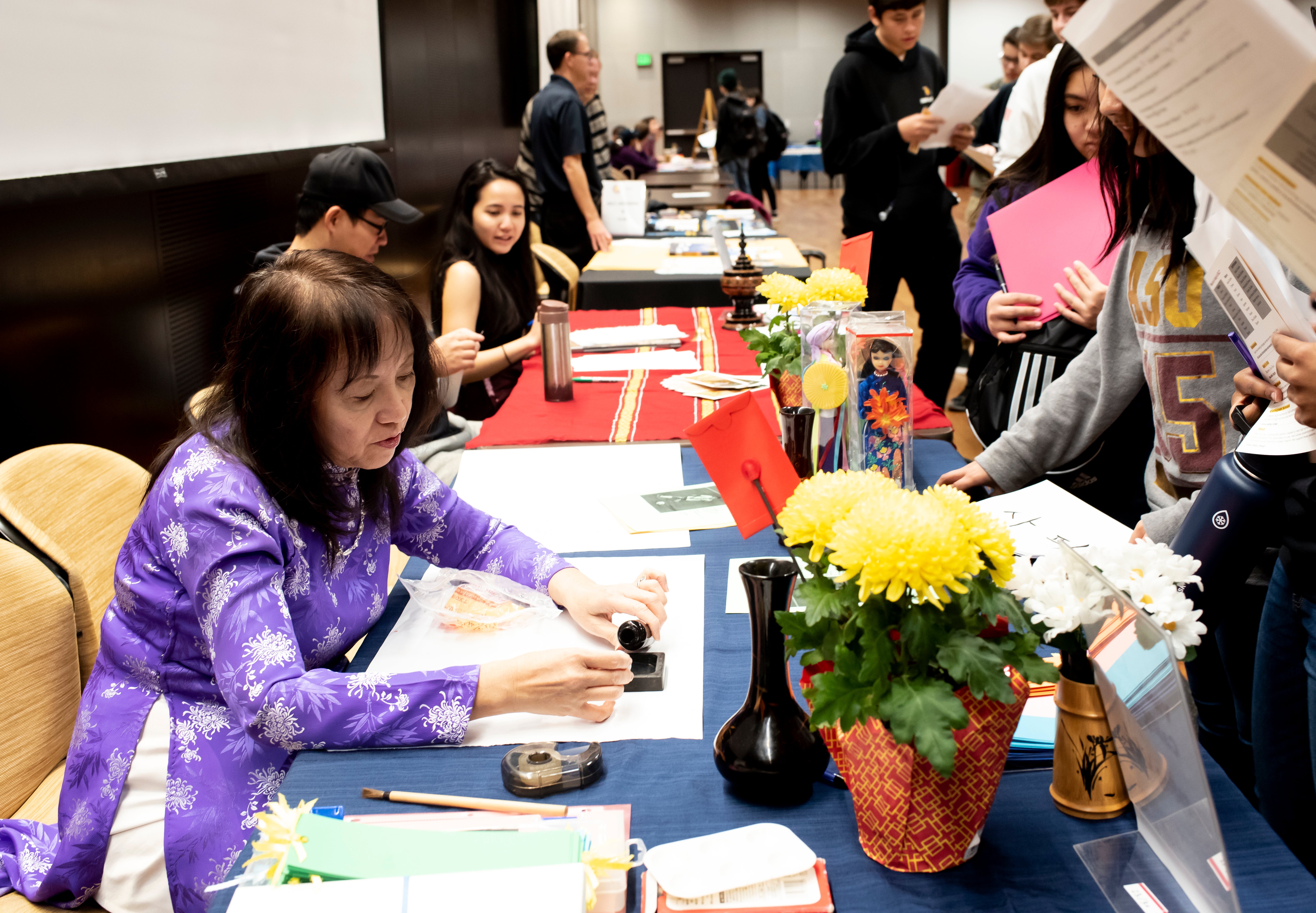 ASU Vietnamese language lecturer Thuy-Kim Le writes names in Vietnamese ink calligraphy for visiting students.