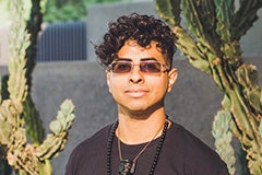 man posing in front of cactus