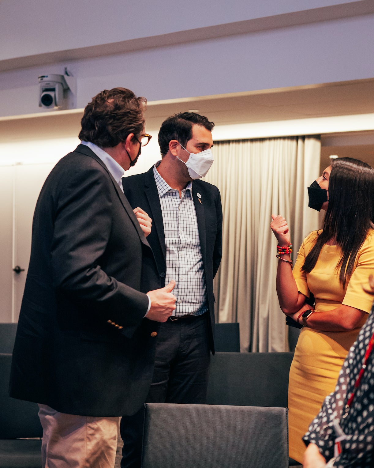 Three people talking at event