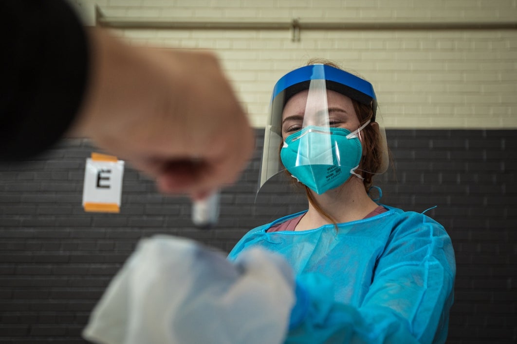 Woman accepting a vial