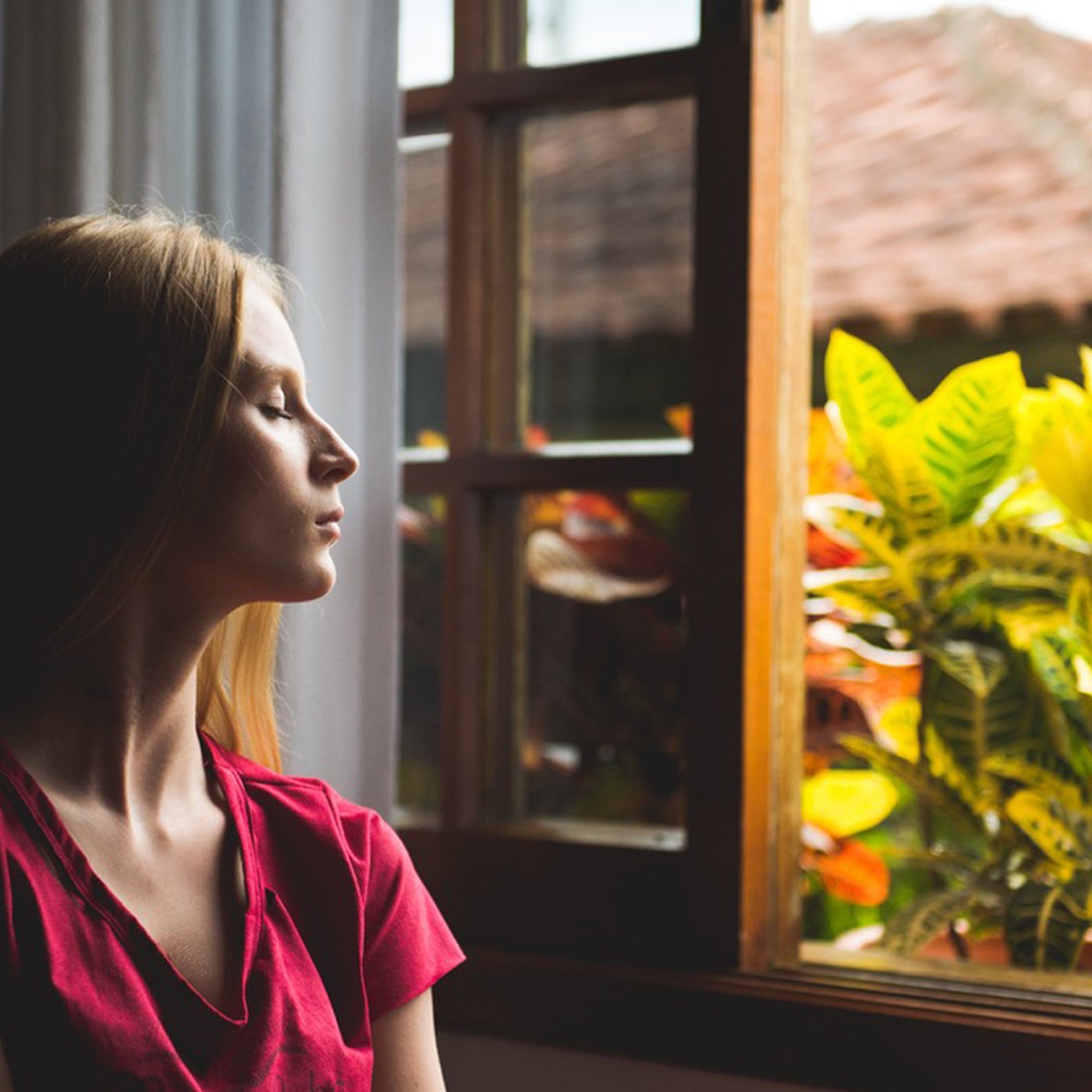 woman looking out window