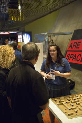 woman talking to people at presentation