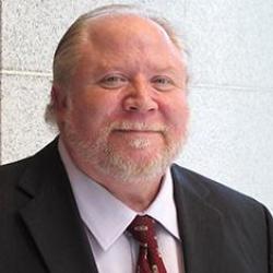 Man in beard and suit smiling