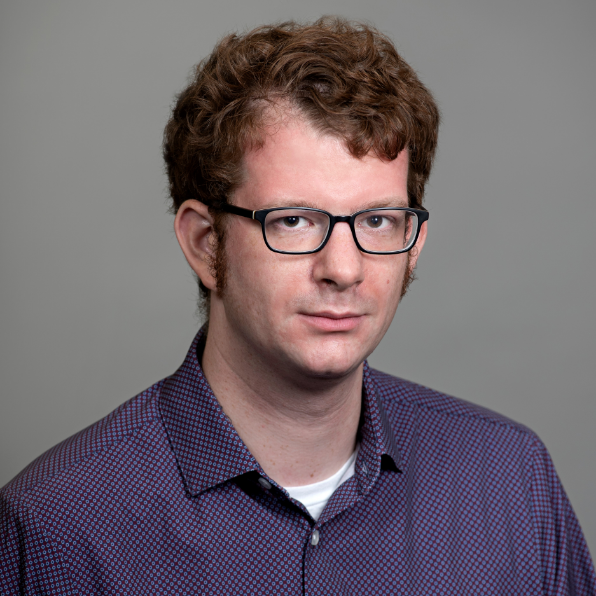 Man in glasses and purple shirt