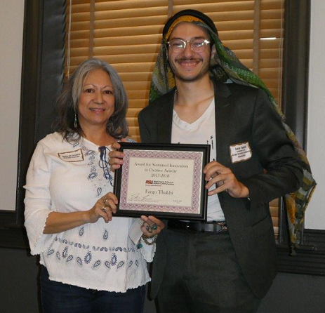 student and professor holding an award