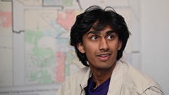 Portrait of young man in front of map