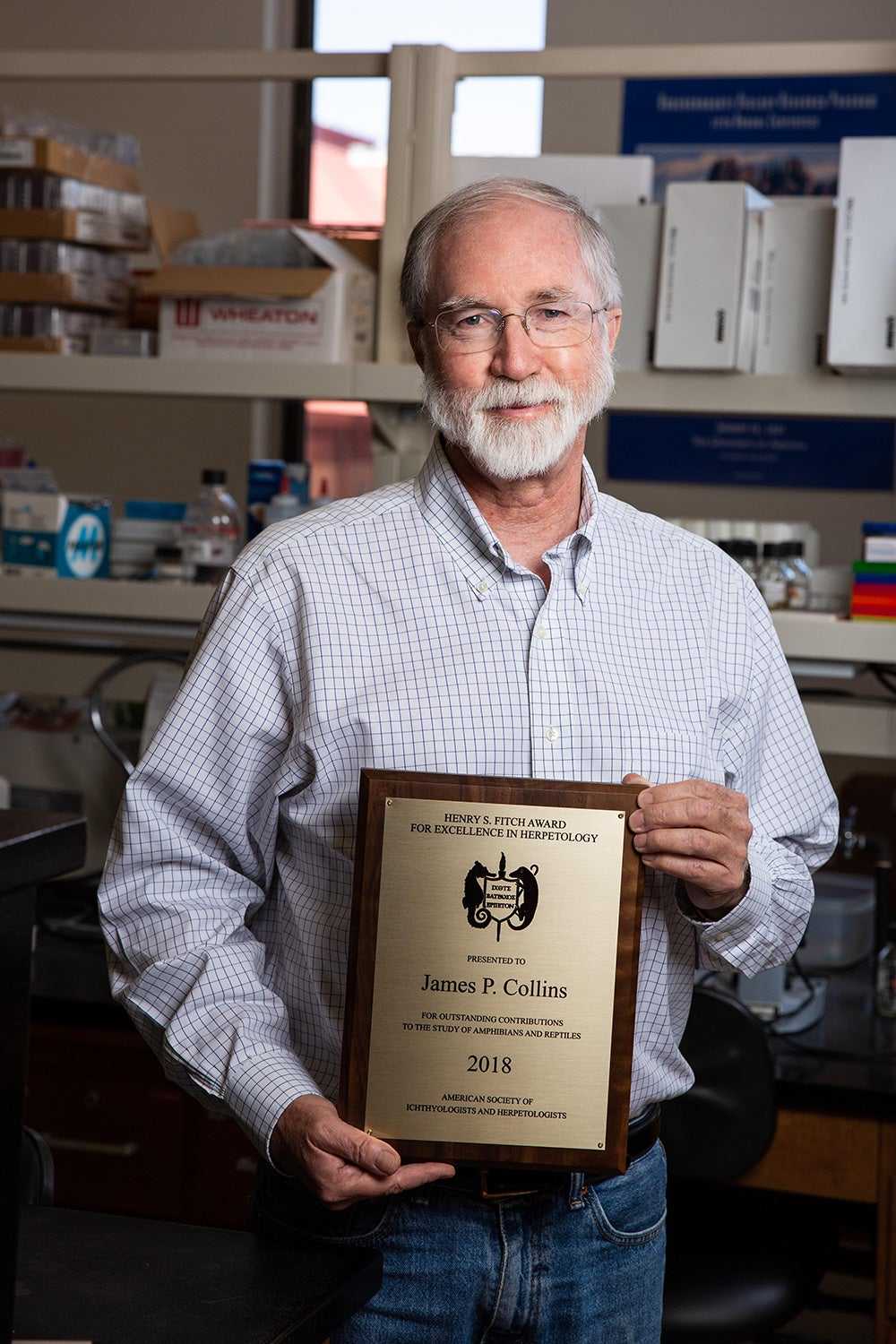 man holding award in lab