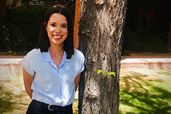 woman posing next to tree