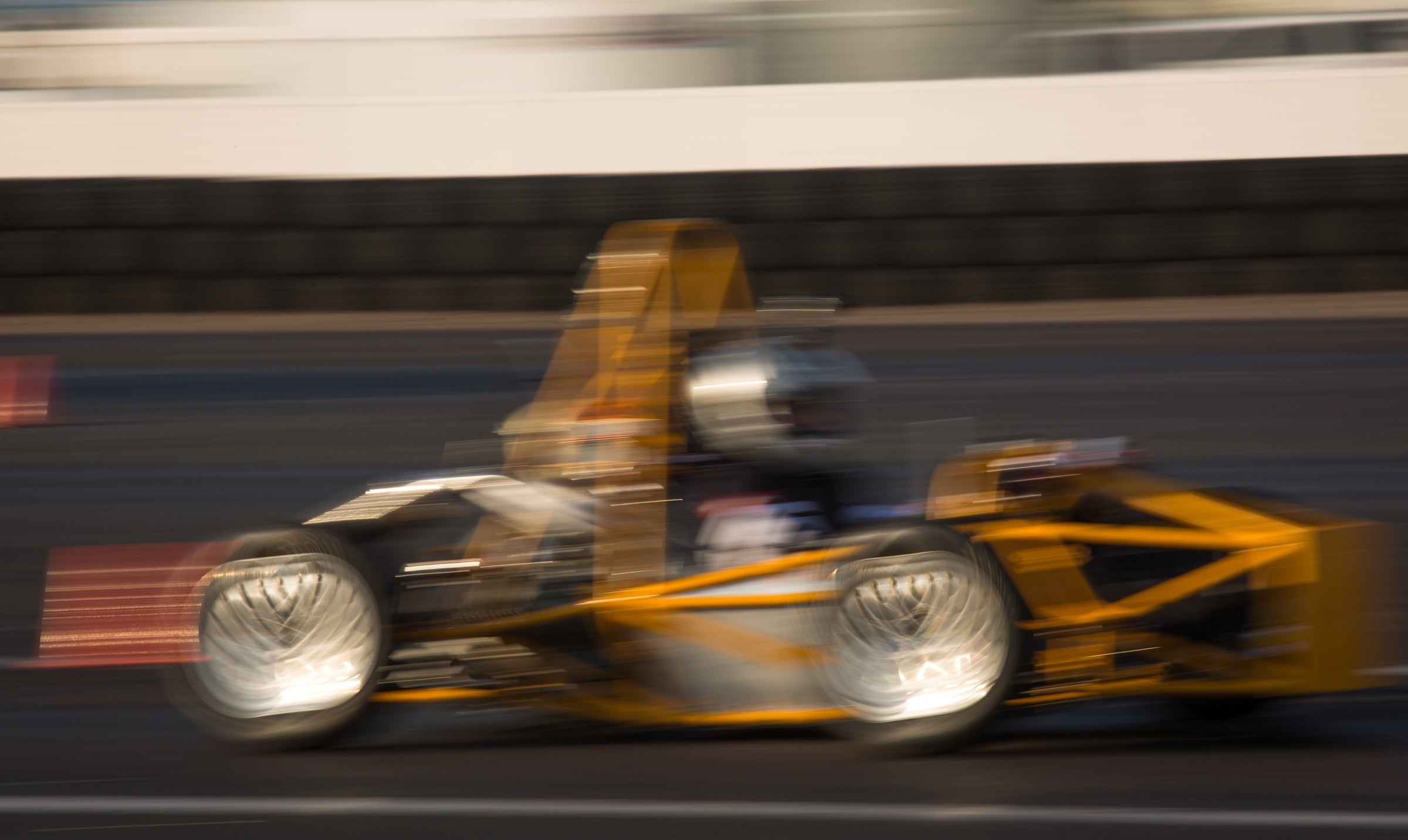 Students test drive their Formula SAE race car on the track.