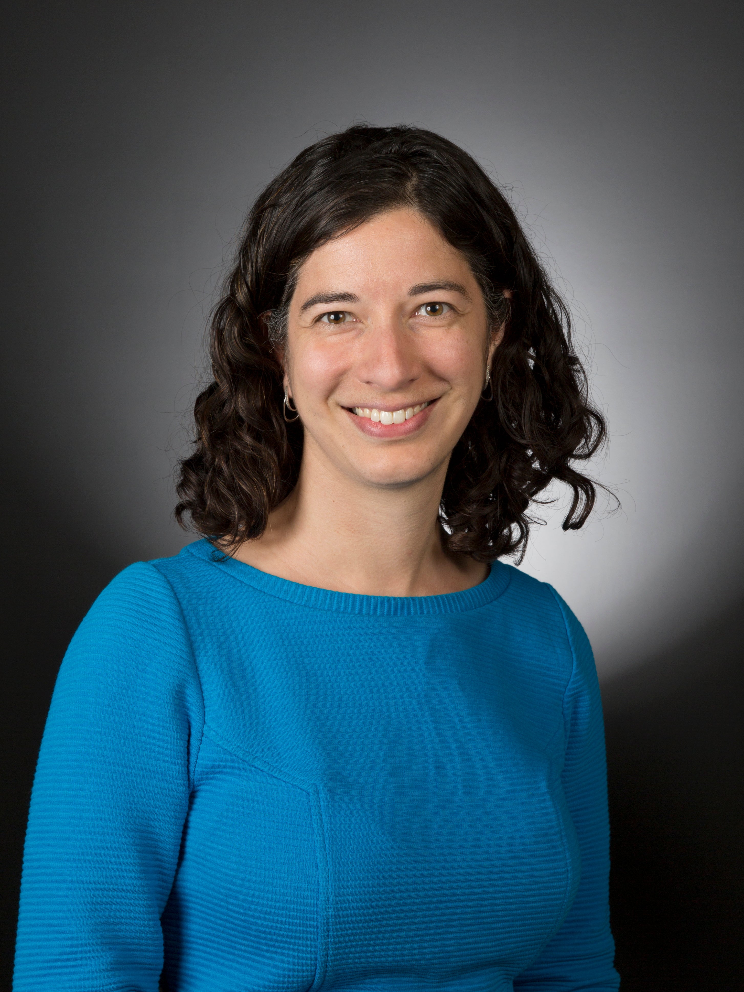 Woman in blue shirt smiling