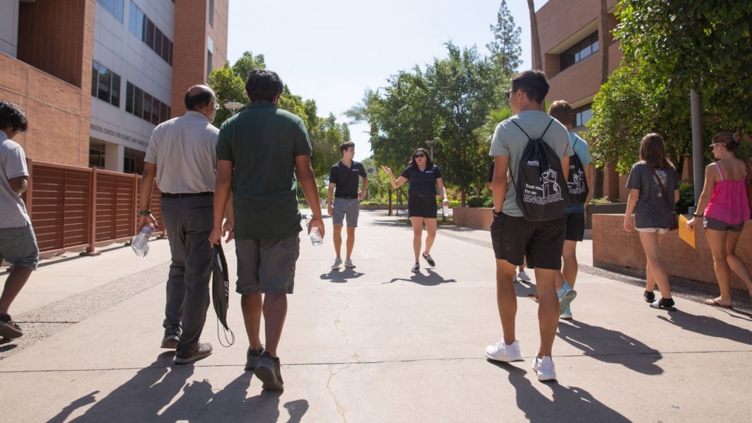 A group of people participate in a tour of the ASU Tempe campus with the Fulton Ambassadors.