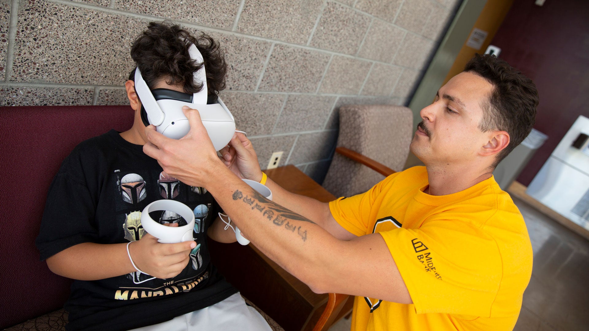 Engineering student Gil E. Ruiz (right) works with his son to develop a virtual reality method of therapy for children with autism spectrum disorder.