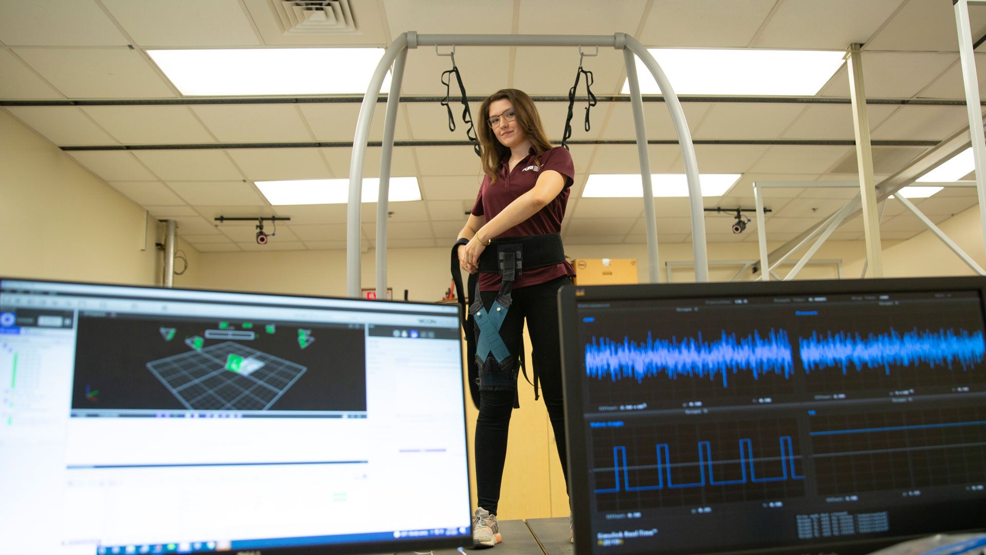 Lily Baye-Wallace demonstrates a soft robotic hip exosuit.