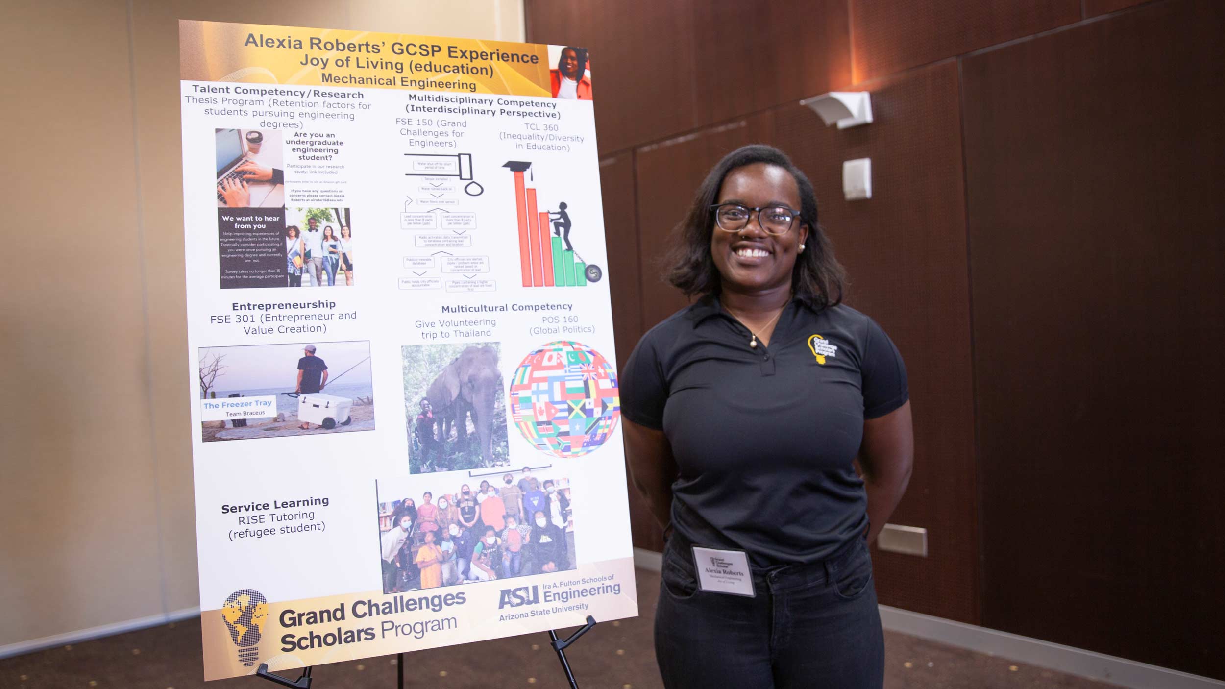 Student standing next to poster presentation