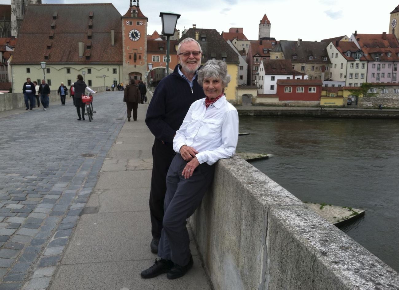 two people standing on bridge on vacation