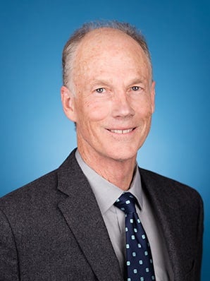 Man in suit and tie smiling