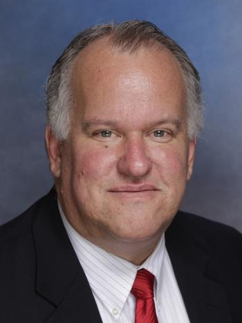 Man in red tie smiling