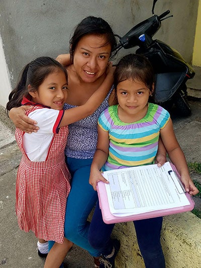 Woman smiling with her two daughters