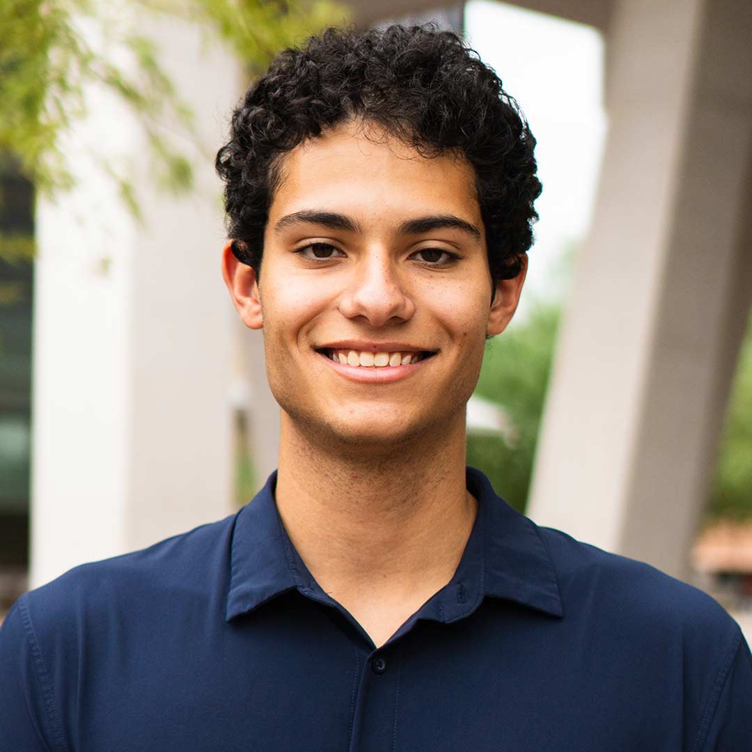 Undergraduate student  smiles at the camera.