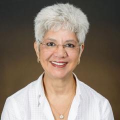 Woman with gray hair and glasses