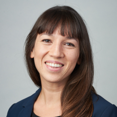 Portrait of female professor with long brown hair and bangs