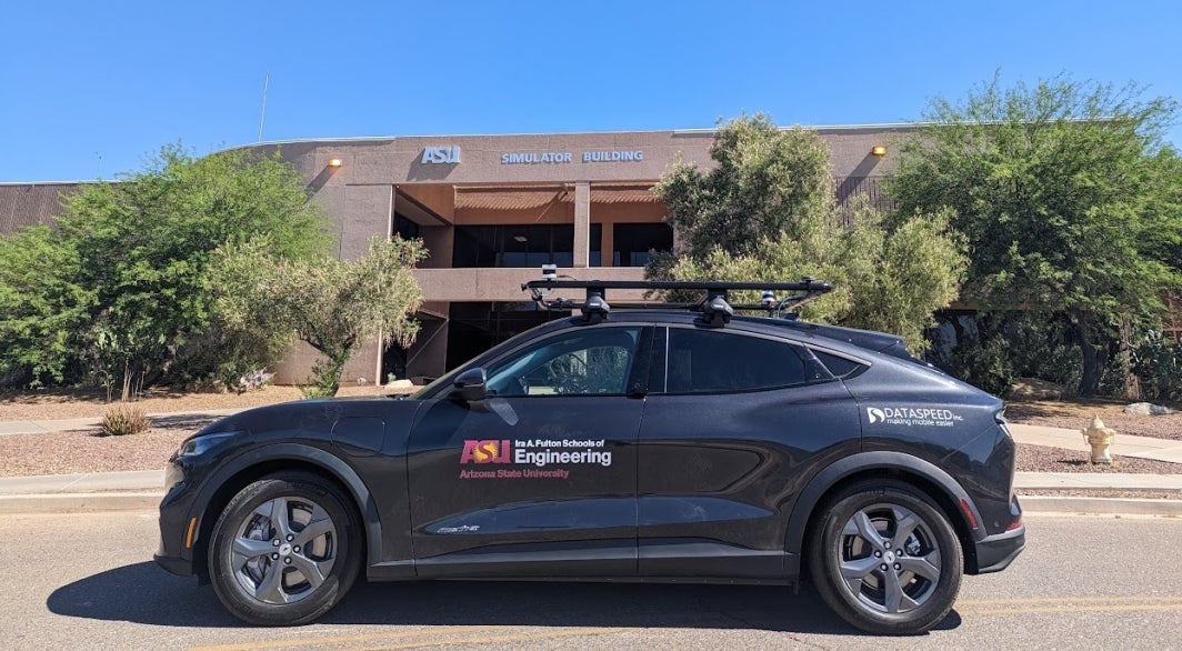 A parked autonomous vehicle with the Fulton Schools logo