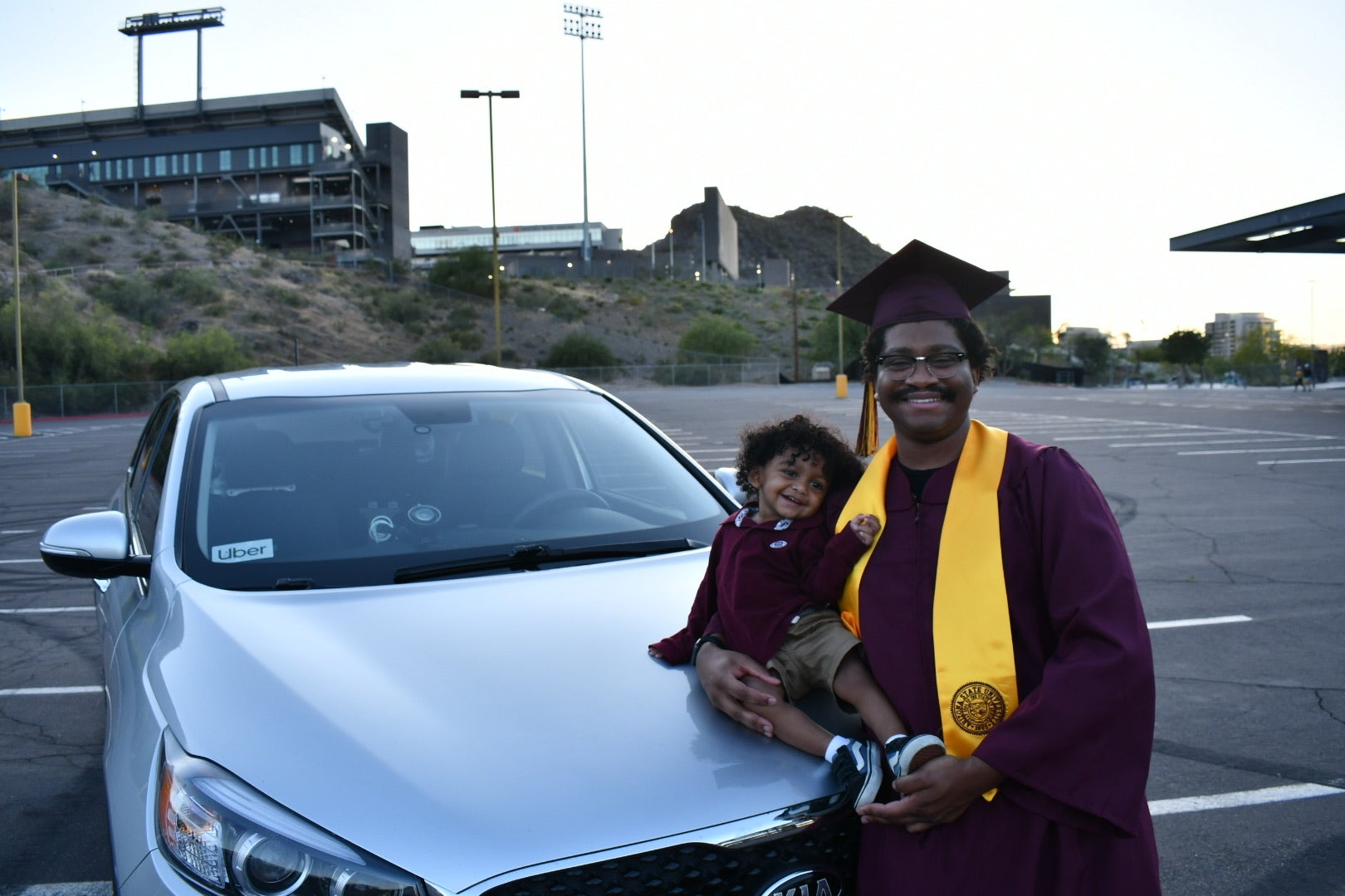 Man in cap and gown with son