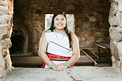 woman standing in opening in old stone building