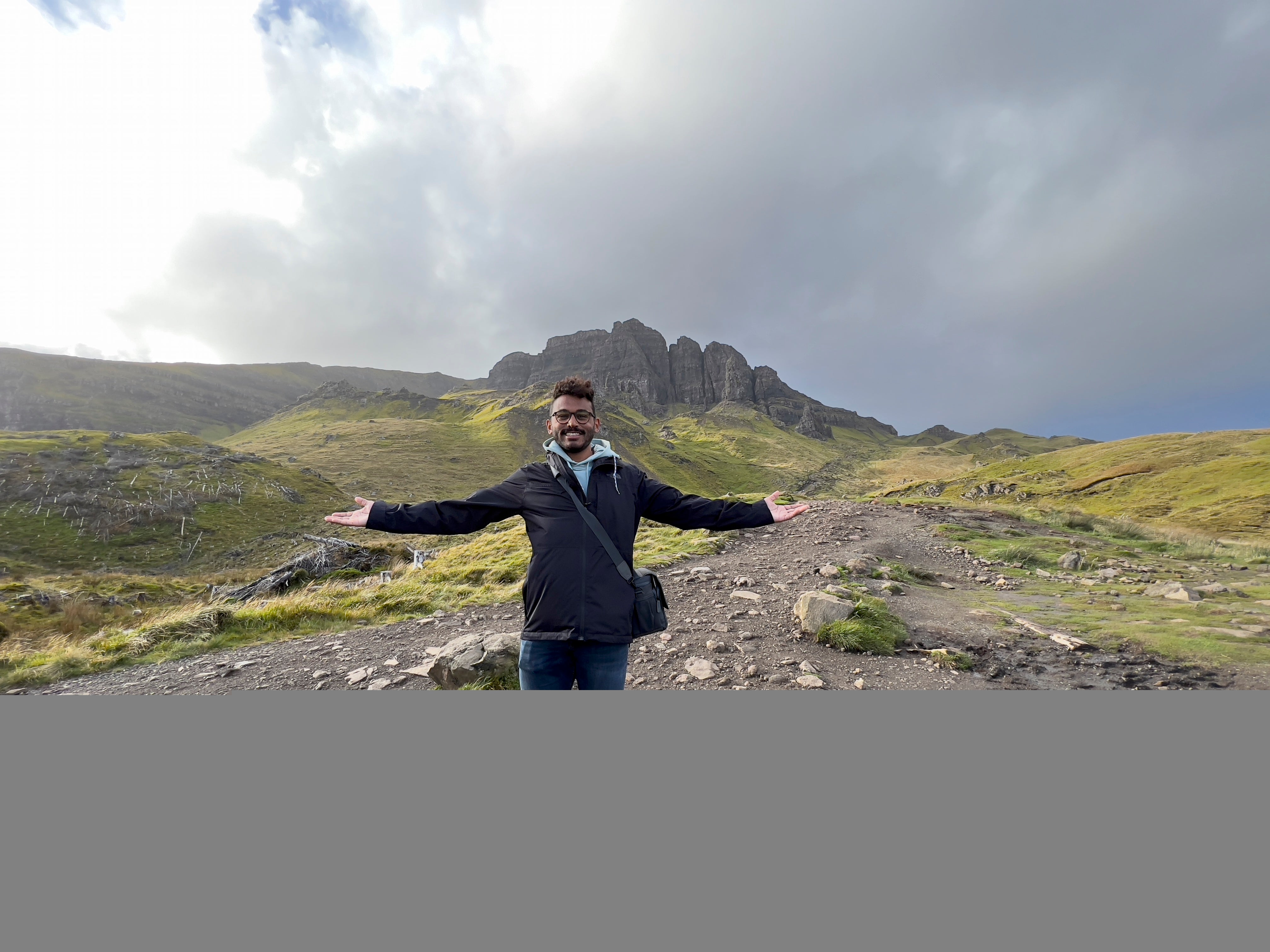 Student posing in front of mountain range