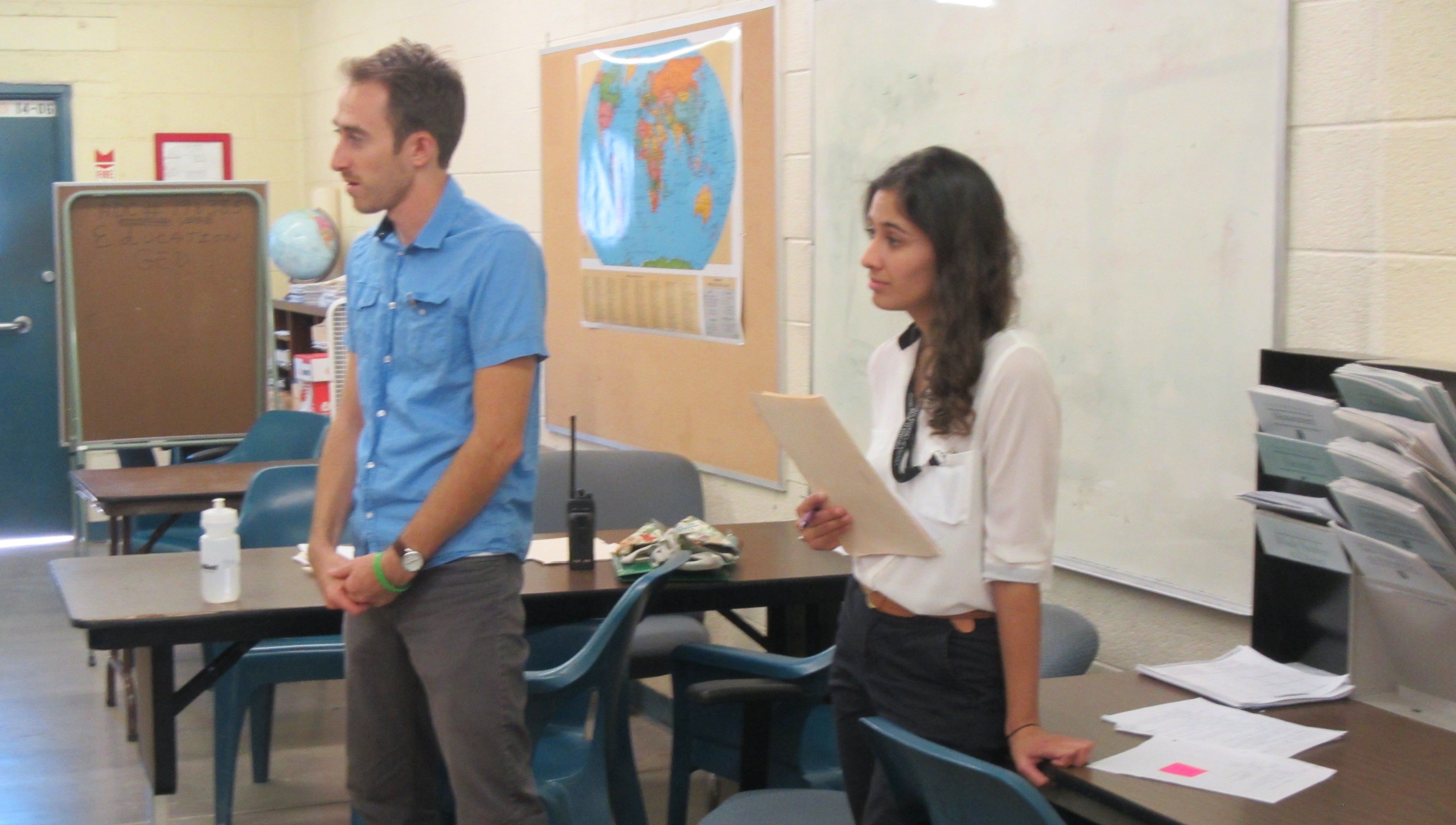 Two ASU students stand at the front of a classroom