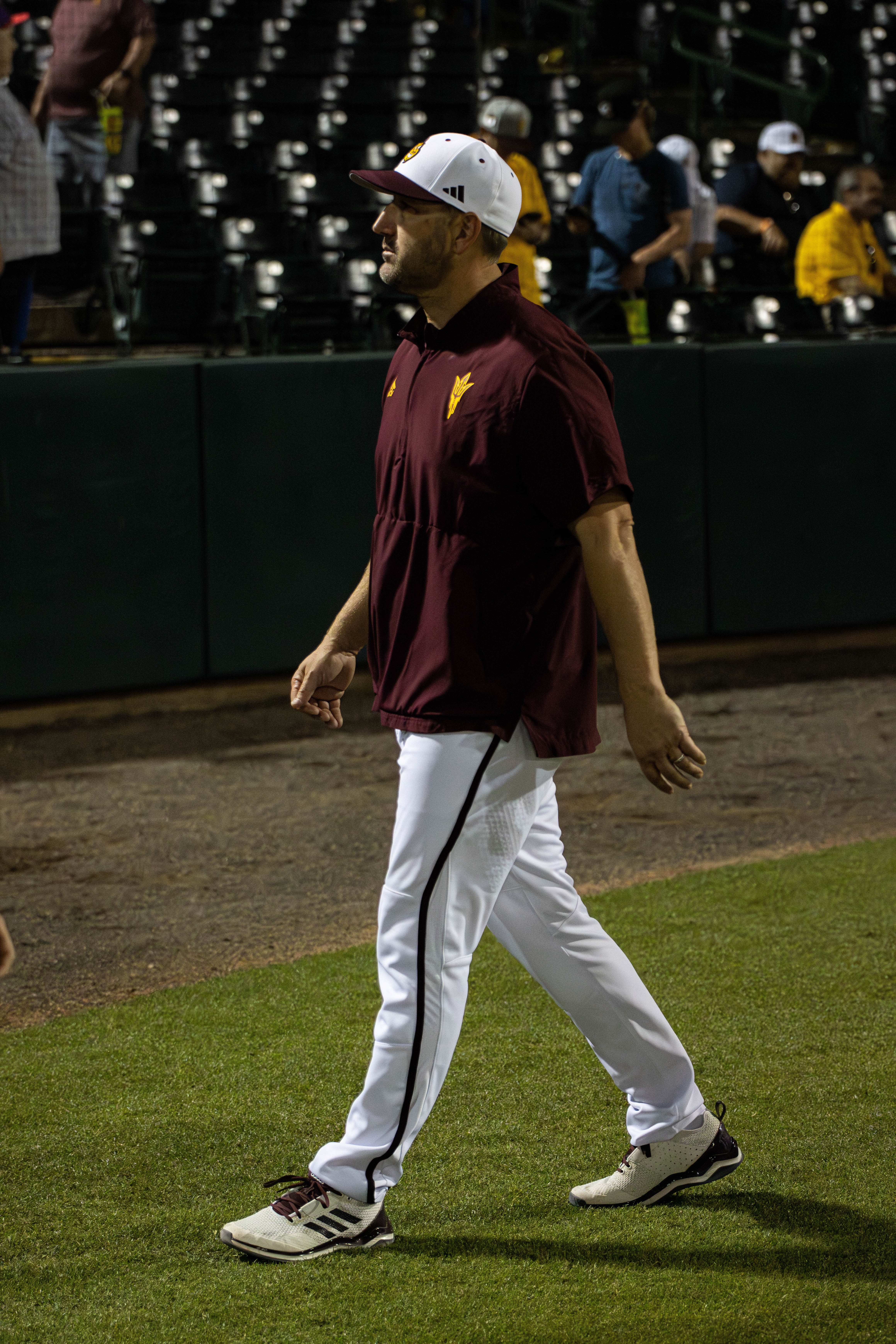 Baseball coach walking on field