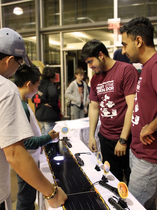 Ussama Khalid Barki (left) and Usman Salahuddin (right) explain how photovoltaics could change the energy situation in their home country at Night of the Open Door – Polytechnic. Photographer Erika Gronek/ASU