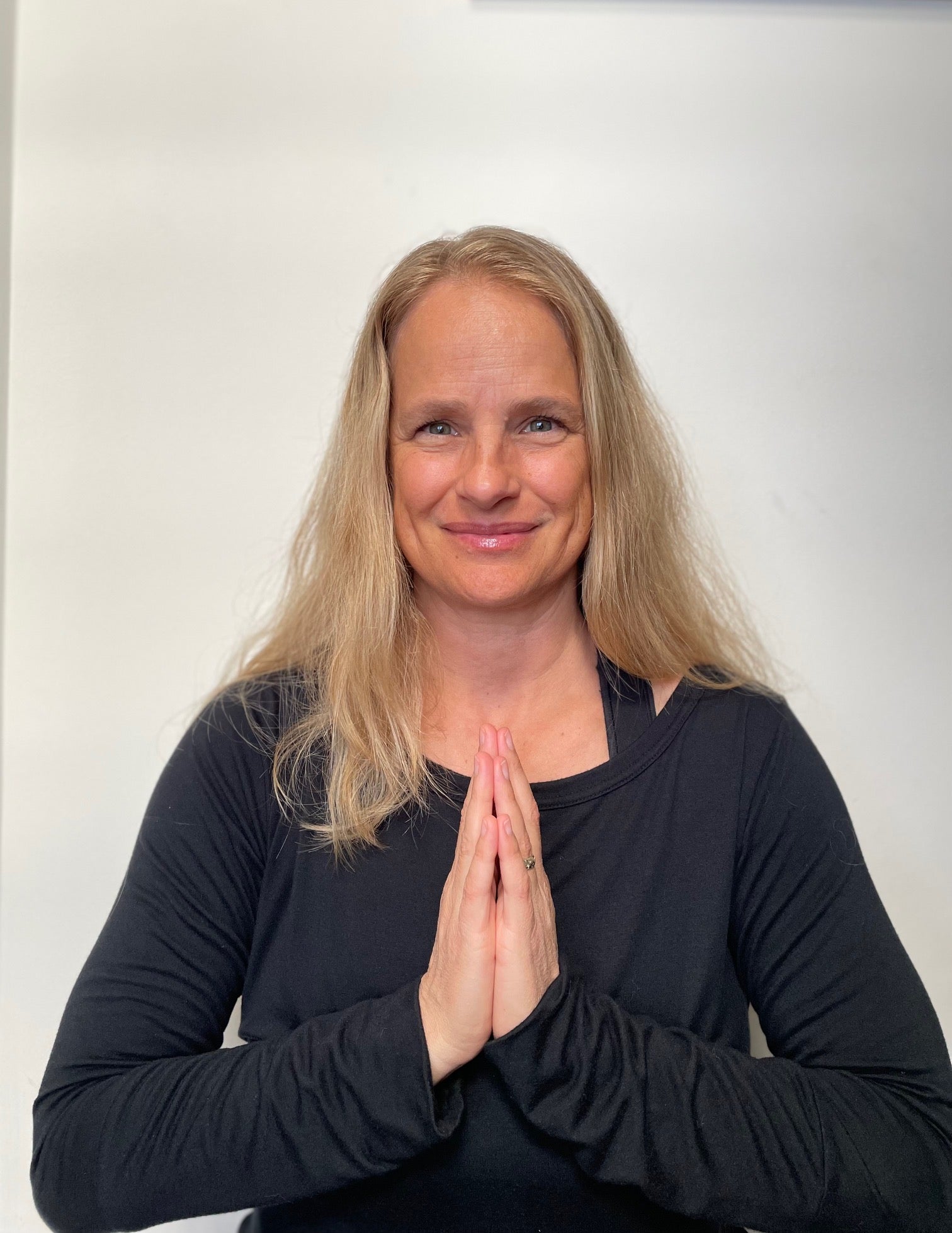 woman posing with hands in prayer