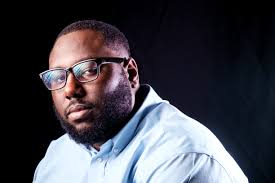 Black man in glasses and blue shirt