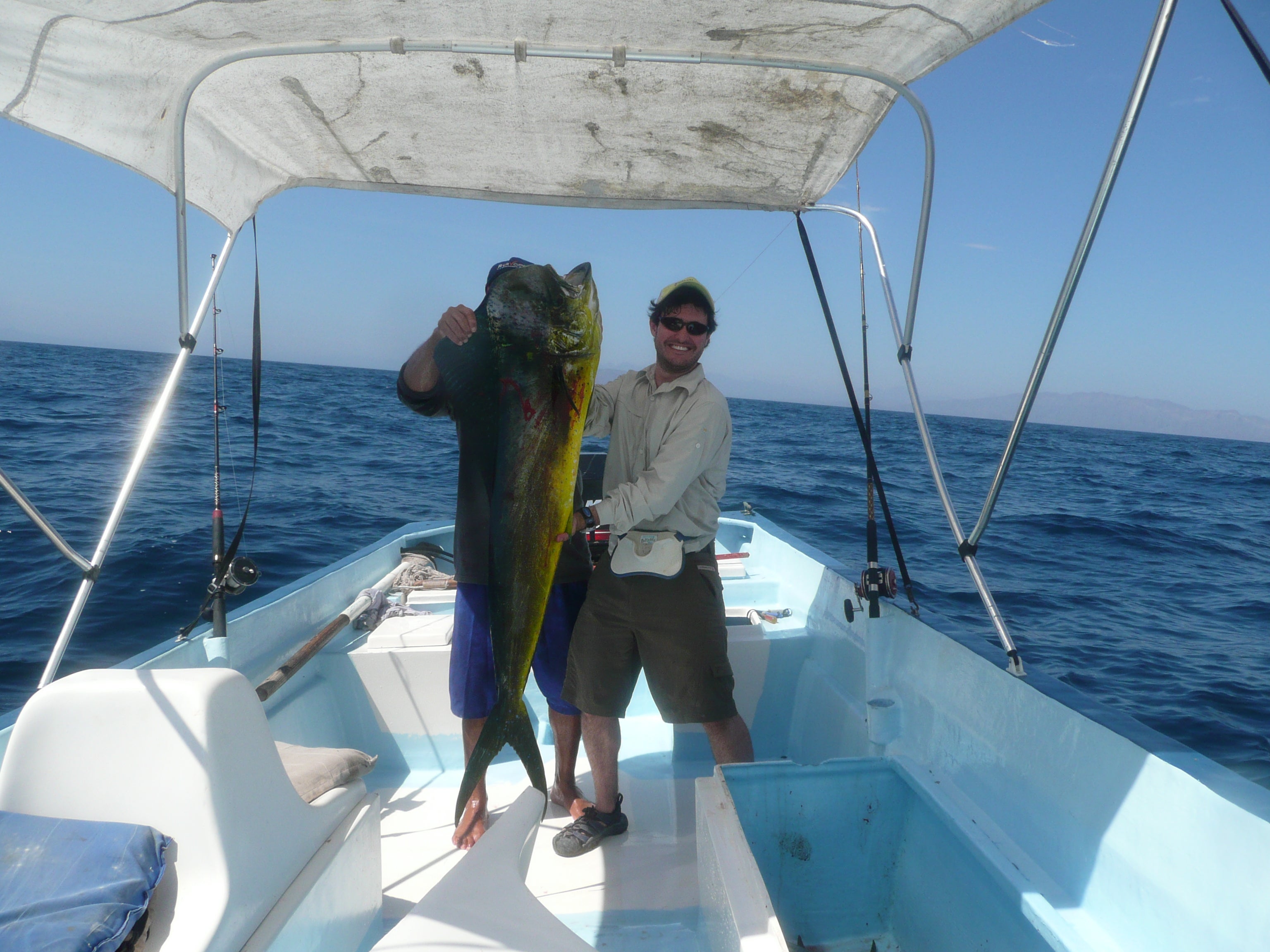 Fishermen hold a dorado