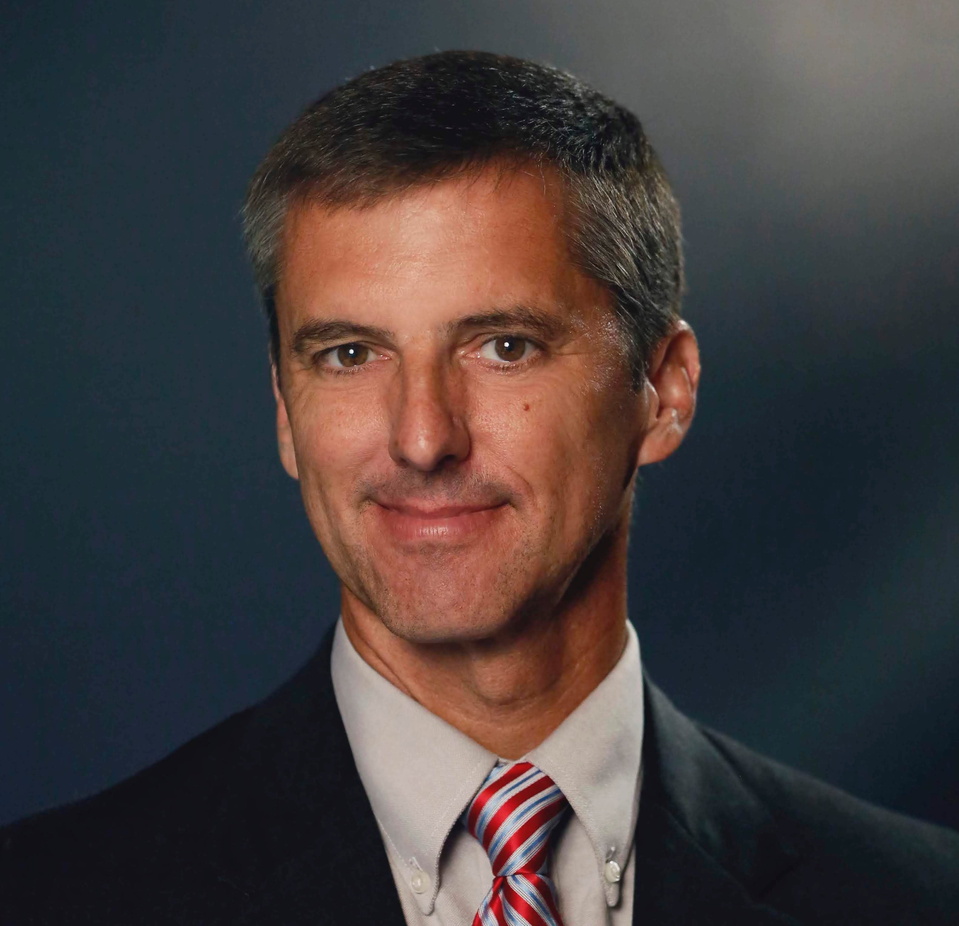 Man in striped tie smiling