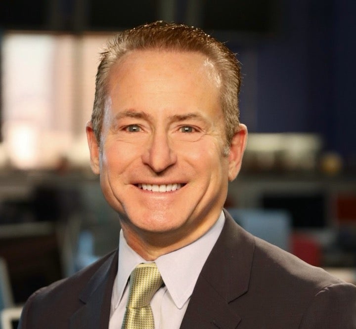 Man in brown suit and yellow tie