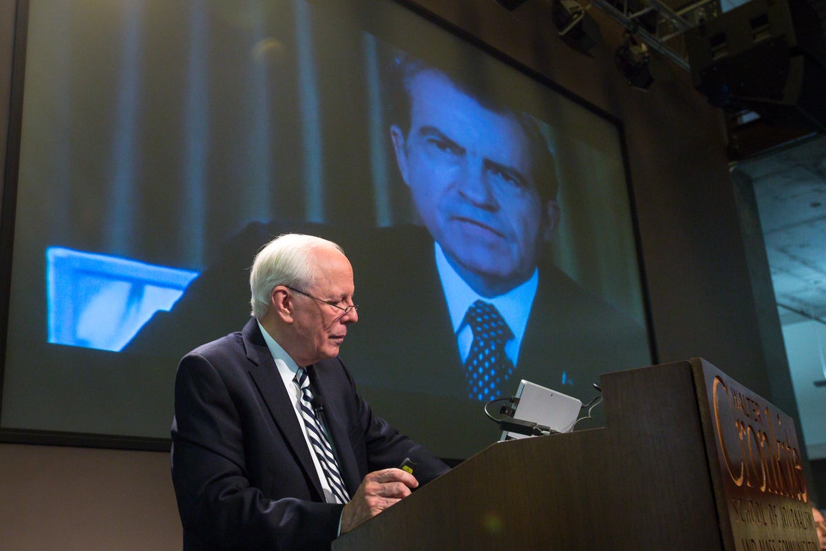 man speaking at podium