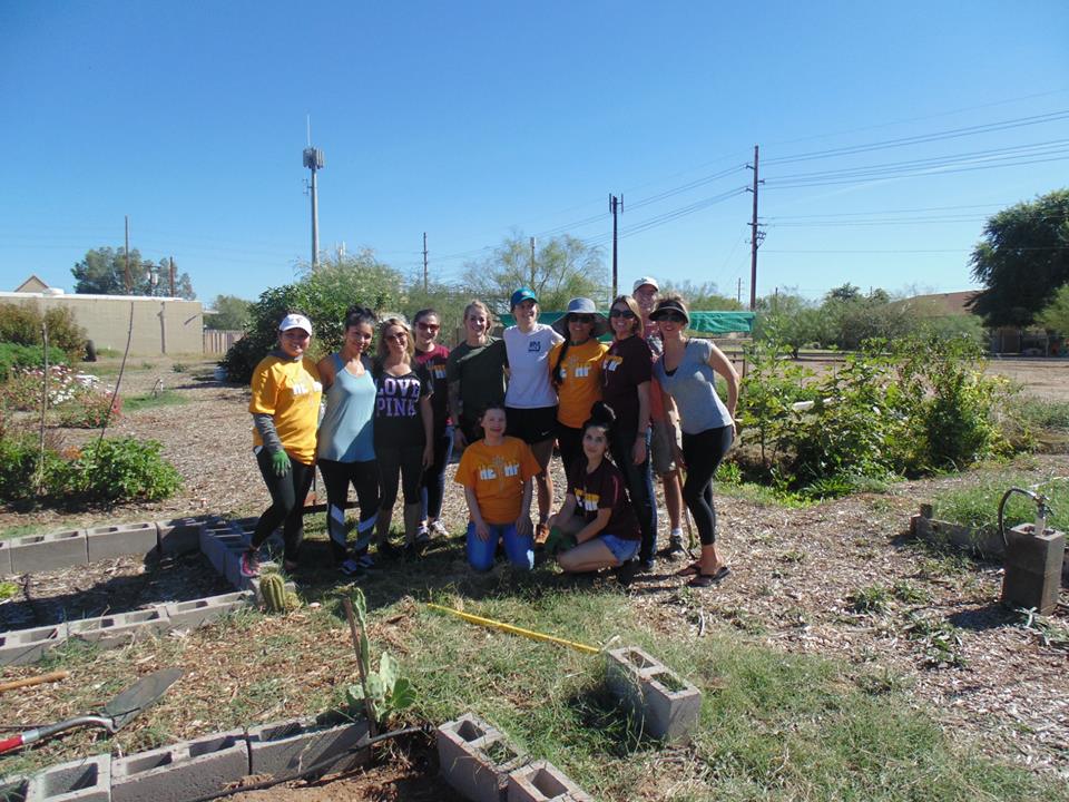 group photo of student club in an urban garden