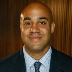 Man in suit and tie smiling