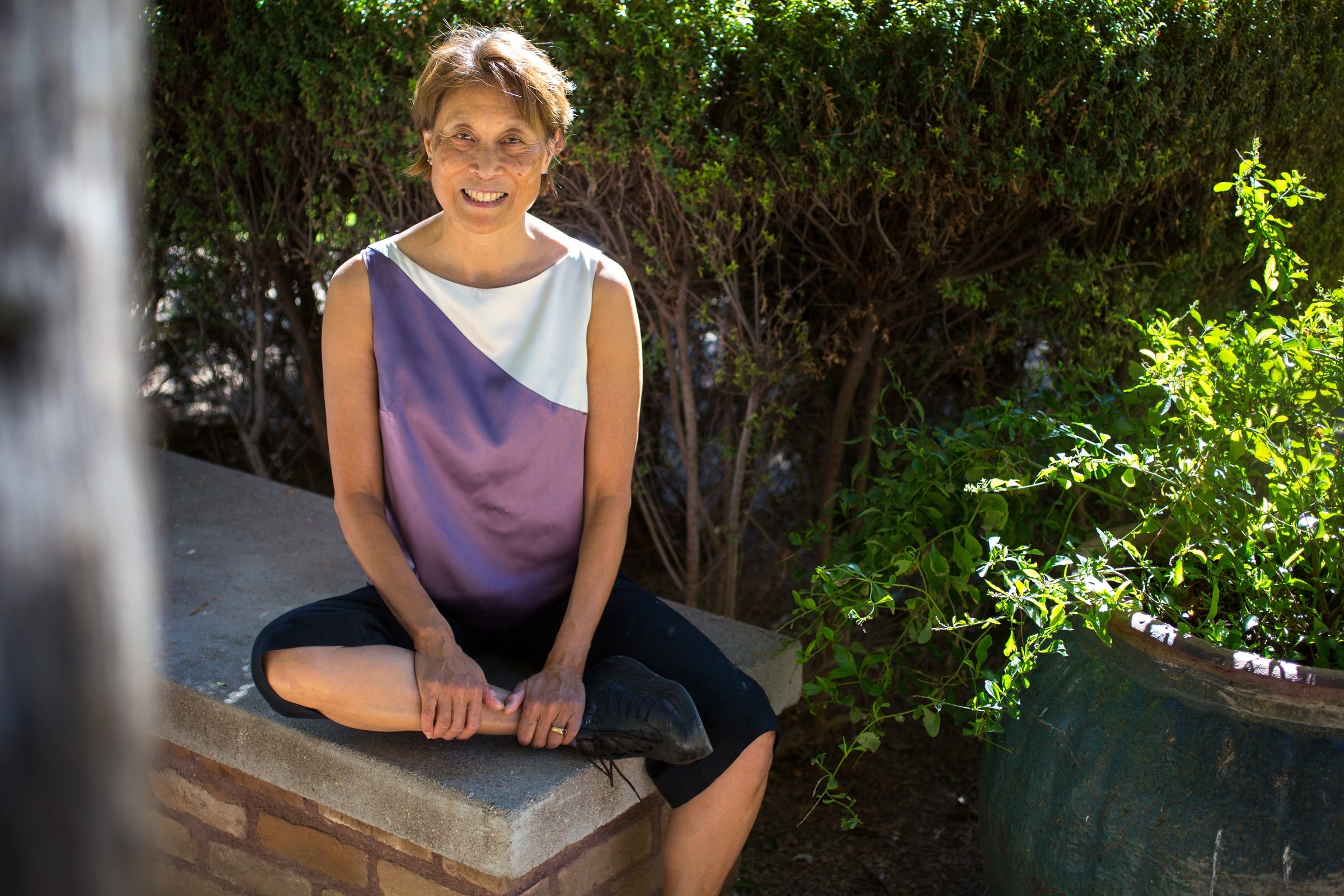 woman sitting on bench in garden