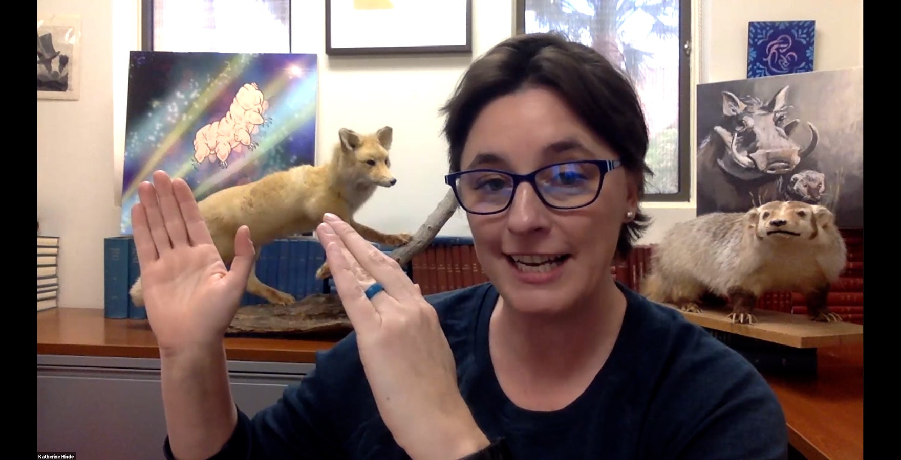 Woman wearing glasses in an office with taxidermy animals