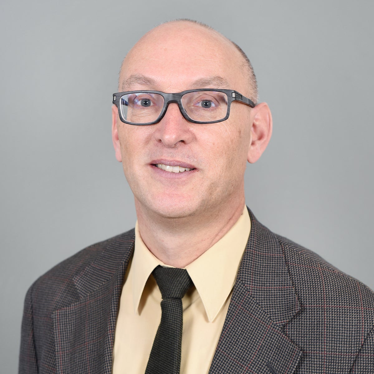 Man in glasses and tweed jacket