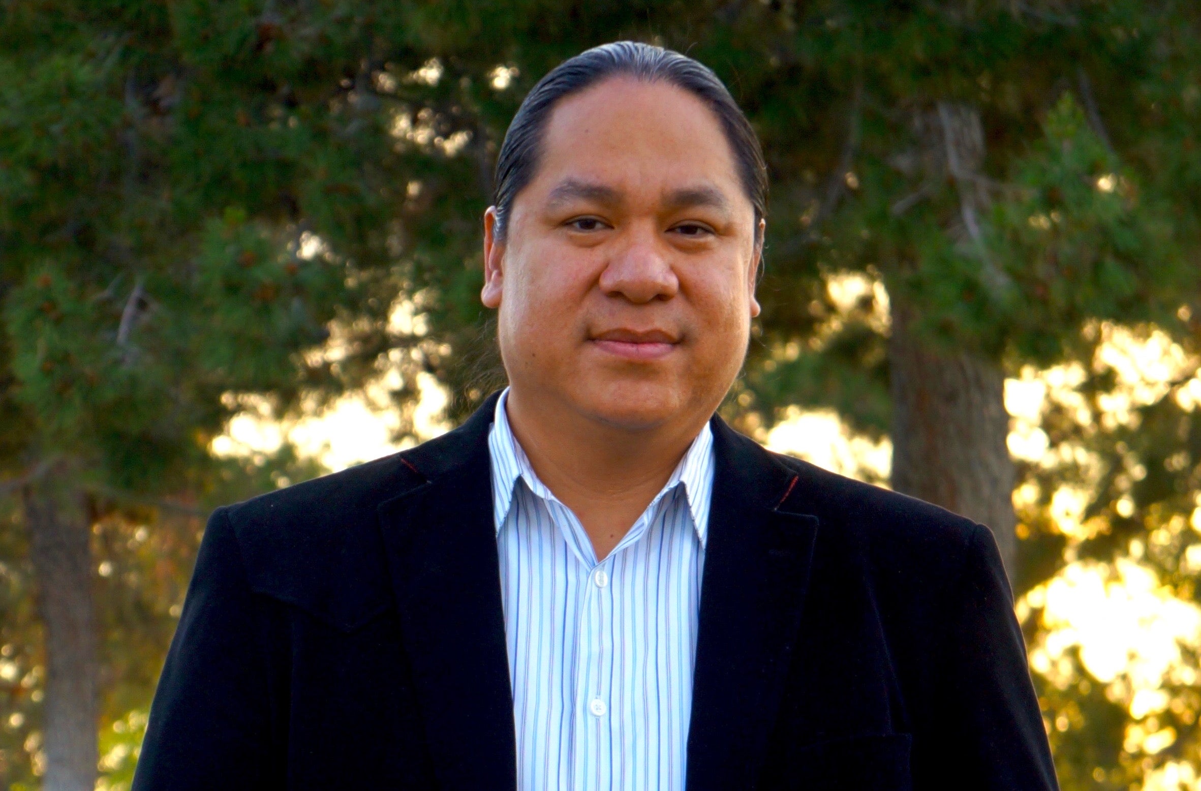 Man in ponytail and black jacket